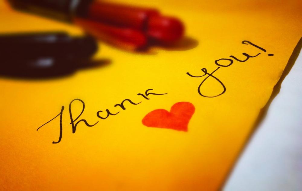 yellow thank you card with thank you and red heart text